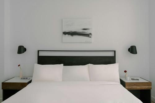 a bedroom with a large white bed with two night stands at Sonder by Marriott Bonvoy The Witherspoon Apartments Center City in Philadelphia