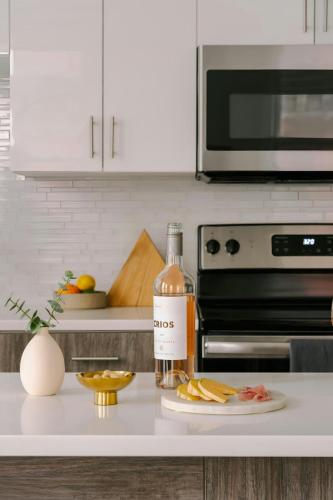 a bottle of wine sitting on top of a kitchen counter at Sonder by Marriott Bonvoy The Witherspoon Apartments Center City in Philadelphia