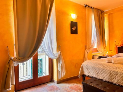 a bedroom with a bed and a large window at Locanda Dei Baroni in Vasto