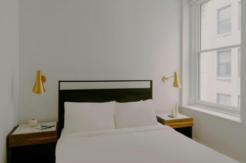 a bedroom with a white bed and a window at Sonder by Marriott Bonvoy The Witherspoon Apartments Center City in Philadelphia