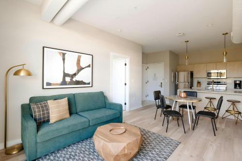 a living room with a blue couch and a table at Sonder by Marriott Bonvoy The Edison Apartments Old City in Philadelphia