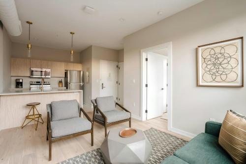 a living room with a couch and chairs and a kitchen at Sonder by Marriott Bonvoy The Edison Apartments Old City in Philadelphia
