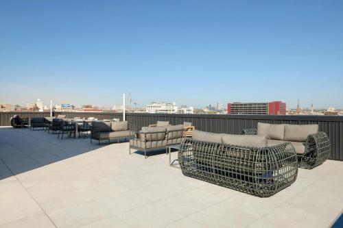 a patio with couches and tables and chairs on a roof at Sonder by Marriott Bonvoy The Edison Apartments Old City in Philadelphia