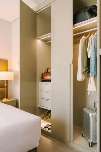 a bedroom with a bed and a closet at Sonder by Marriott Bonvoy Business Bay Apartments in Dubai