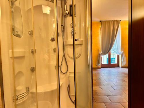 a bathroom with a shower with a glass door at Locanda Dei Baroni in Vasto