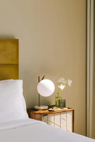 a bedroom with a bed and a lamp on a table at Sonder by Marriott Bonvoy JBR The Walk Apartments in Dubai