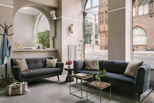 a living room with a couch and a table at Sonder by Marriott Bonvoy Royal Garden Apartments New Town in Edinburgh