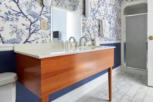 a bathroom with a sink and blue and white wallpaper at The Arco Hotel Midtown Village, Sonder by Marriott Bonvoy in Philadelphia