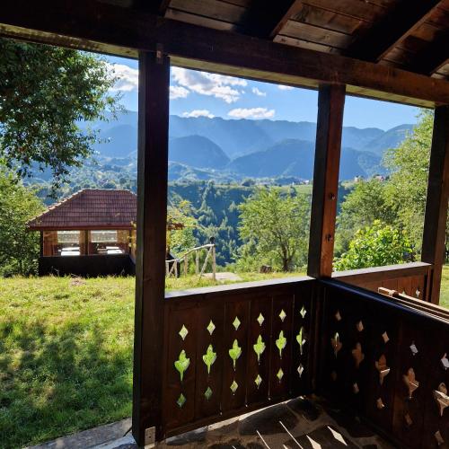 a screened porch with a view of the mountains at Alpine Escape Studios in Măgura