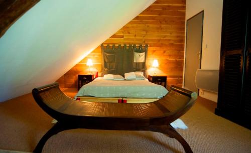 a bedroom with a bed in a attic at Le Gite de la Passerelle à Crévoux in Crévoux