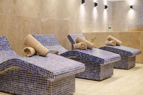 four tables and chairs with towels on top of them at Gold Majesty Hotel in Bursa