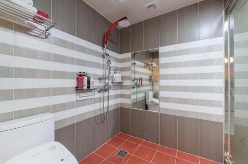 a bathroom with a shower and a toilet at Gwangju Hanam 1st Hotel in Gwangju