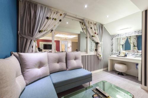 a living room with a couch and a table at Gwangju Hanam 1st Hotel in Gwangju