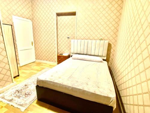 a bedroom with a bed in a room with a mirror at sphinx one centre hotel in Banī Ghālib