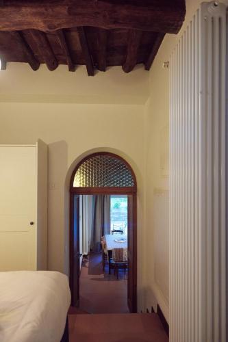 a bedroom with a bed and a dining room with a table at Agriturismo Fattoria Poggio di Fiesole in Fiesole