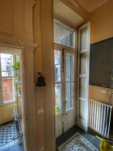 a room with two windows and a room with a hallway at il glicine guest house in Alessandria