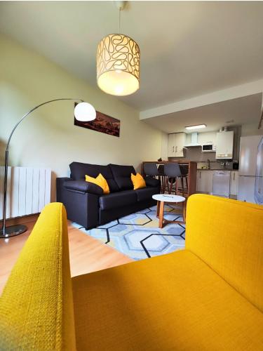 a living room with a couch and a table at Apartamento Punta Escarra in Escarrilla