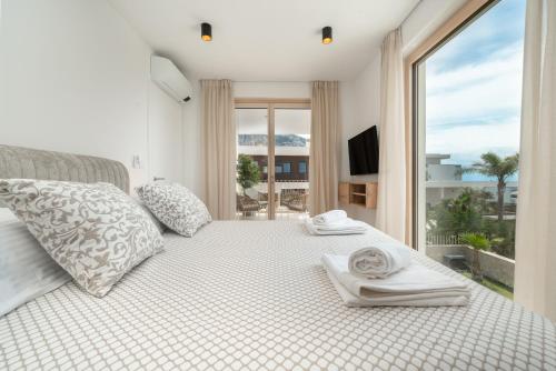 a bedroom with a bed with a large window at NEW! Villa Adore Makarska in Makarska