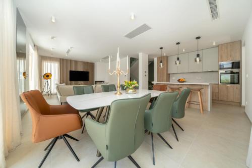 a kitchen and dining room with a table and chairs at NEW! Villa Adore Makarska in Makarska