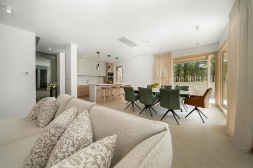 a living room and kitchen with a couch and a table at NEW! Villa Adore Makarska in Makarska