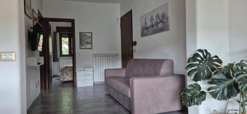 a living room with a couch and a chair at Da Lisa in Desulo