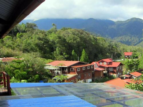 a view from the balcony of a resort with mountains in the background at Mile 36 Lodge in Kundasang