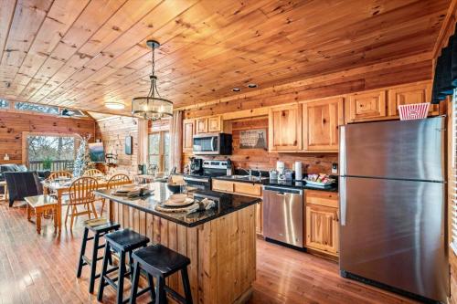 a kitchen with a stainless steel refrigerator and wooden cabinets at Blue Ridge Retreat in Pigeon Forge