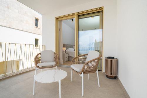 a room with two chairs and a table on a balcony at NEW! Villa Adore Makarska in Makarska