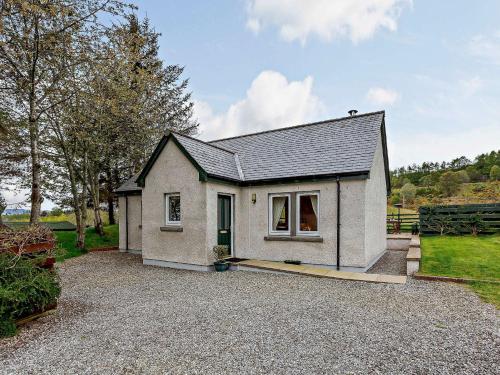 a small white house on a gravel driveway at 1 Bed in Beauly 82779 in Beauly