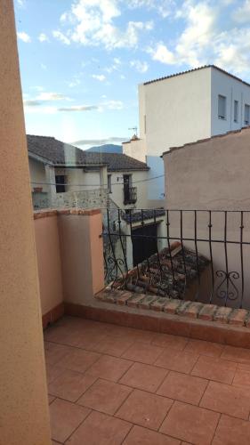 a balcony with a fence and a building at Domo Gallus Zola in Galtellì