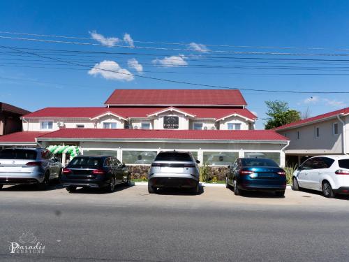 a group of cars parked in front of a building at Pensiunea Paradis Buzias in Buziaş