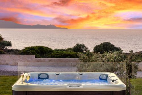 a jacuzzi tub sitting on the side at Luxurious Villas Rocca Blanco 1 & 2 in Kounoupidhianá