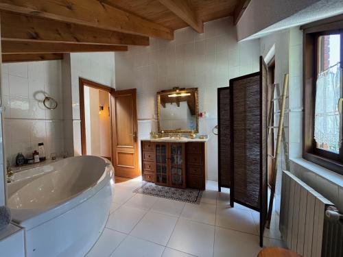 a large bathroom with a tub and a sink at Casa de Robles Cantabria, en el corazón de los Valles Pasiegos in Sel de la Carrera