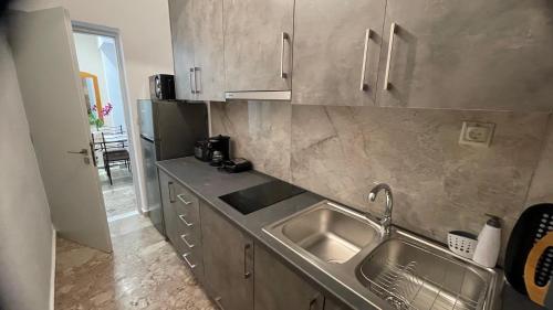 a kitchen with a sink and a counter top at Katerina s House 1 in Nydri