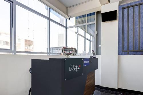 a large room with a counter and windows at Dream Comforts Lodging & Boarding in Bengaluru