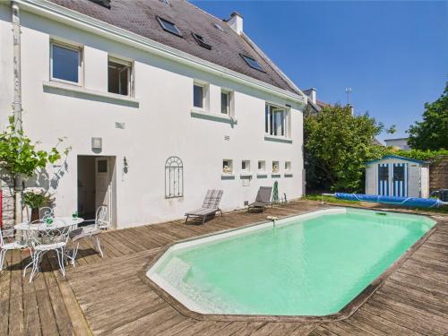 une maison avec une piscine sur une terrasse en bois dans l'établissement -Voltaire- Un havre de paix a deux pas de la plage, à Concarneau