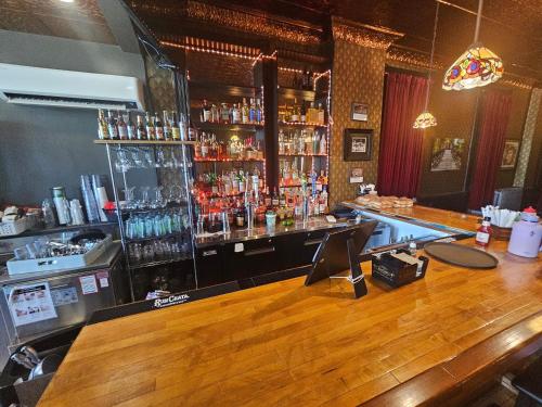 a bar with a wooden counter top and a bar sidx sidx sidx at Albany Merchants Hotel in Albany