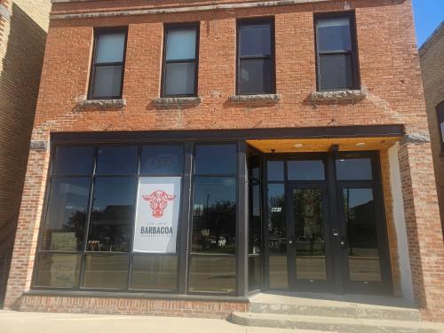 a brick building with a sign in the window at Albany Merchants Hotel in Albany