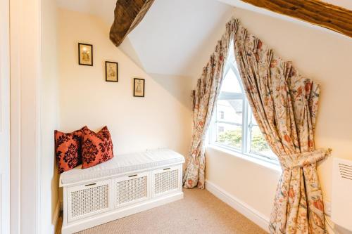 a room with a window and a radiator at The Pheasant Apartment in Bridgnorth