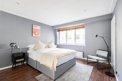 a bedroom with a large bed and a window at Excellent 3 bed House Hyde Park in London