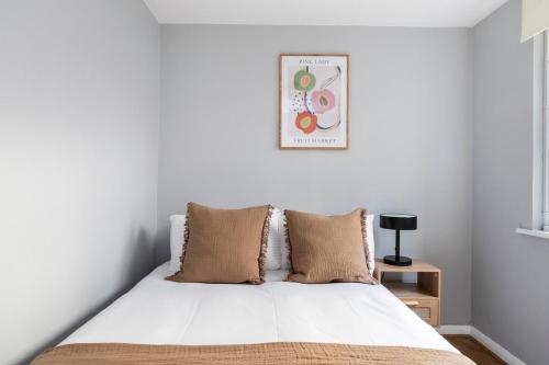 a bedroom with a bed with white sheets at Excellent 3 bed House Hyde Park in London