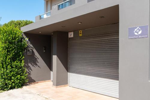 a garage door on the side of a building at DreamCoast Apartments I in Artemida