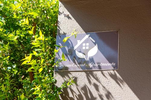 a sign for a house on the side of a building at DreamCoast Apartments I in Artemida