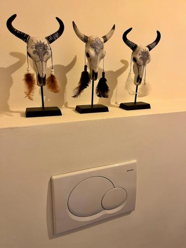a couple of animal heads on display on a shelf at Stylish downtown loft and opposite park in Maldegem