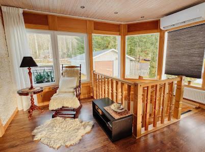 a living room with a staircase with a chair and a table at Paradise-Silvergruvan in Hällefors