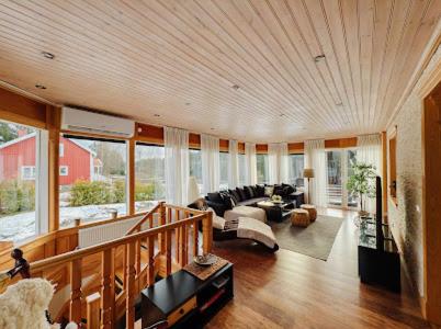 a large living room filled with furniture and windows at Paradise-Silvergruvan in Hällefors