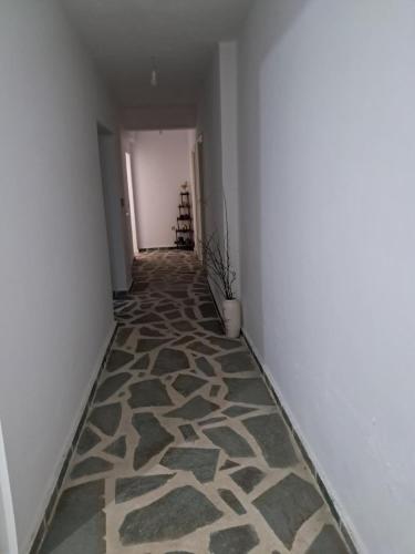 a hallway with a carpeted floor in a room at Aylida House in Paralía Avlídhos