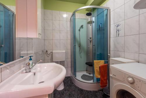 a bathroom with a sink and a shower and a toilet at Dana in Grižane