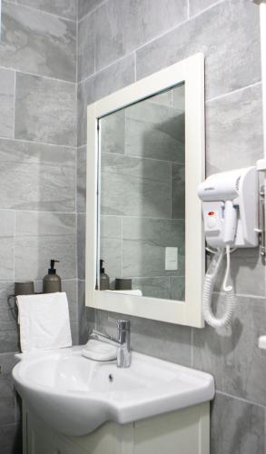 a bathroom with a sink and a mirror at Villa Rosa Boca Chica in Boca Chica
