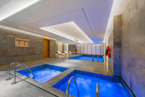 a pool in a hotel room with two swimming pools at Braira Abha Hotel فندق بريرا أبها in Abha